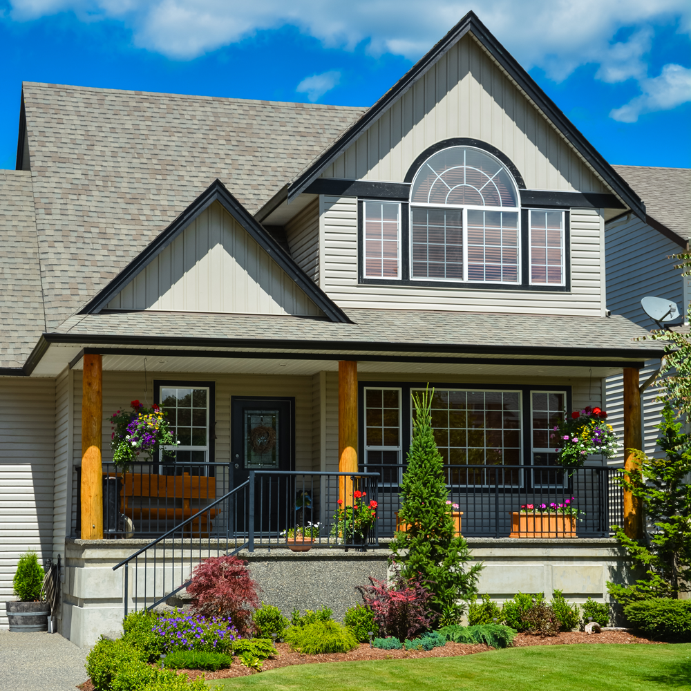 suburban-house-with-landscaping-front-blue-sky-background